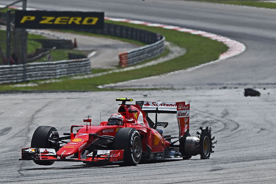 Kimi Raikkonen struggles to keep his Ferrari straight after a tyre blow out