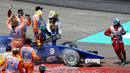Marcus Ericsson climbs from his Sauber after beaching the car in the gravel