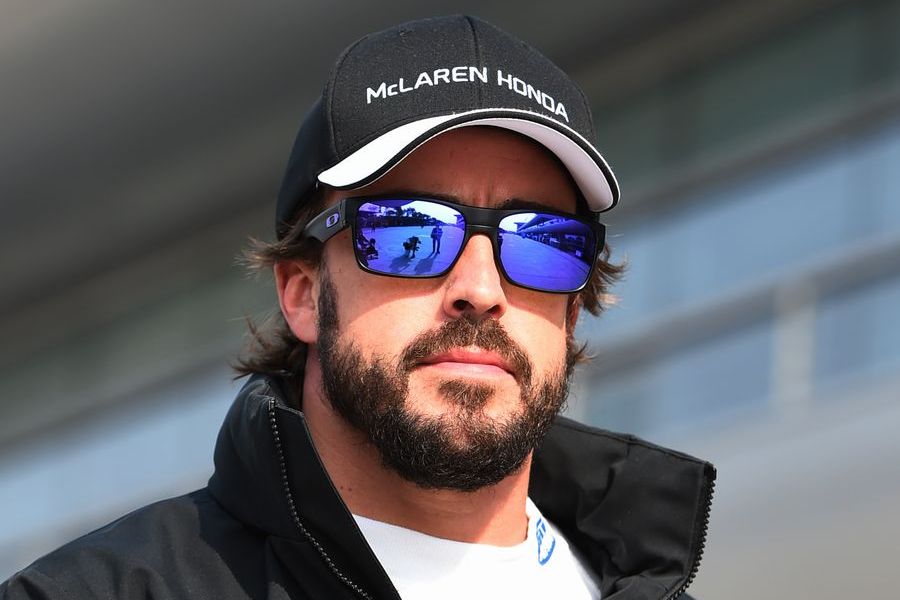 Fernando Alonso walks down the paddock