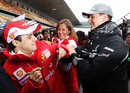 Michael Schumacher attempts to draw on Felipe Massa's coat