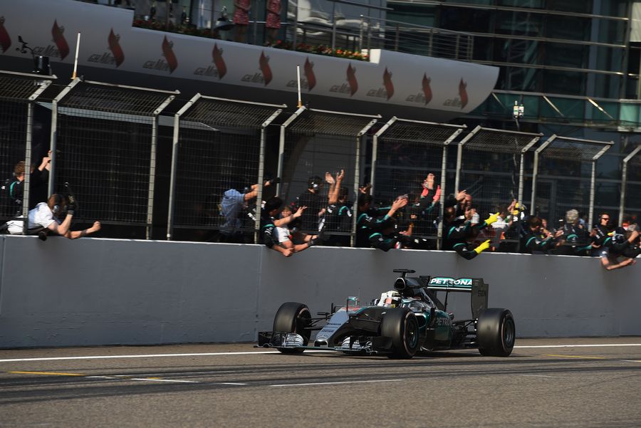 Race-winner Lewis Hamilton crosses the line