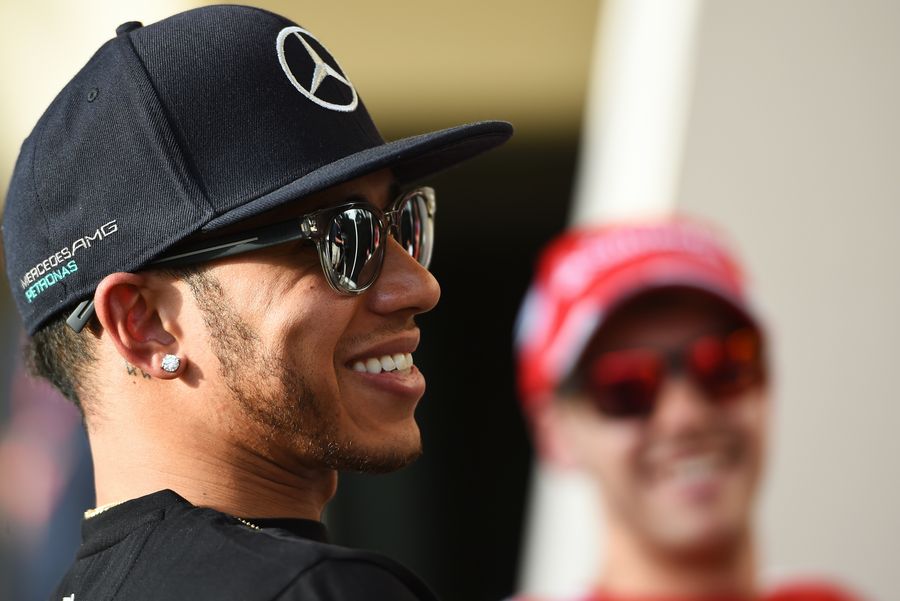 Lewis Hamilton laughs during the cat with Sebastian Vettel