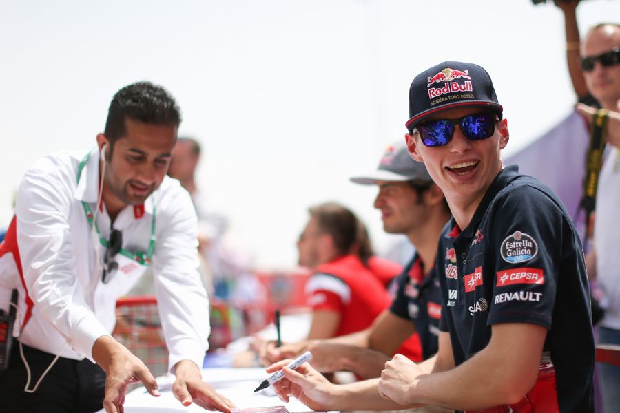 Max Verstappen smiles on during an autograph session