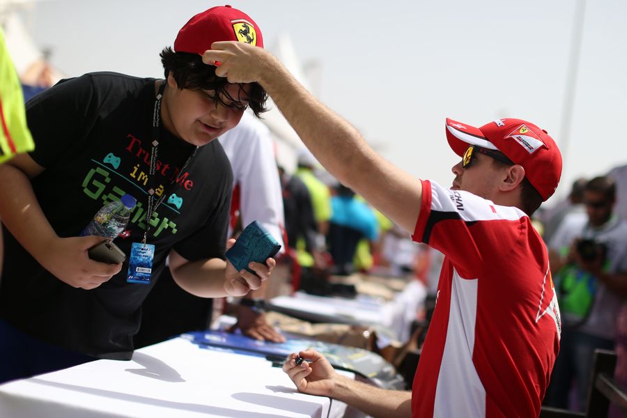 Sebastian Vettel signs autographs for the fans