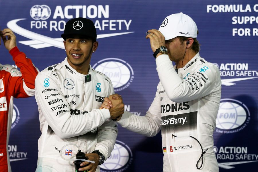 Pole sitter Lewis Hamilton and Nico Rosberg celebrate in parc ferme