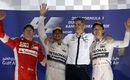 Lewis Hamilton, Kimi Raikkonen and Nico Rosberg acknowledge the crowd during a sombre podium ceremony