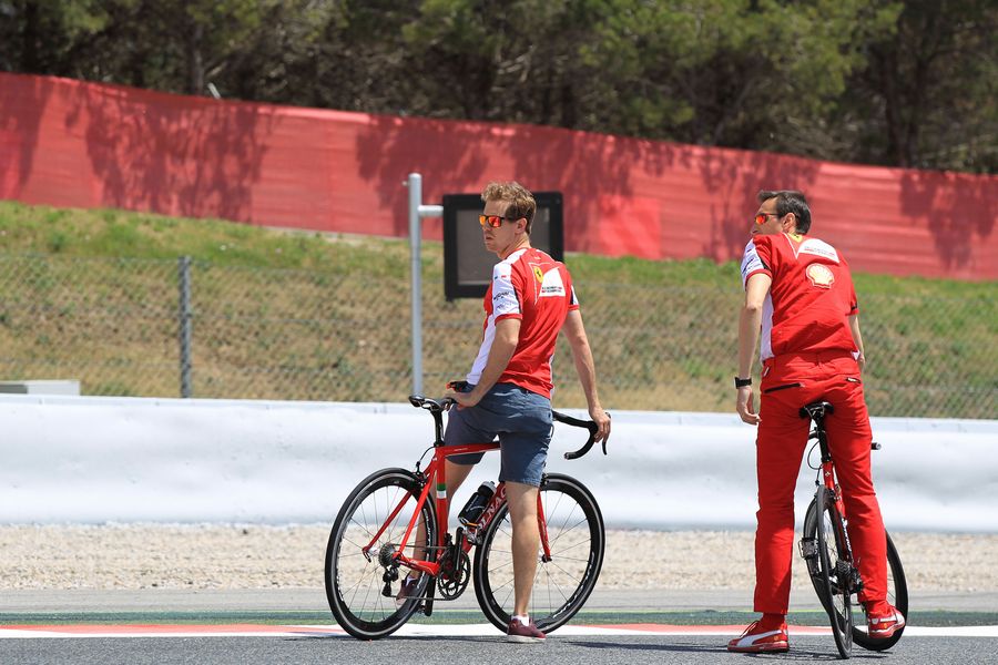 Sebastian Vettel rides his bike around track