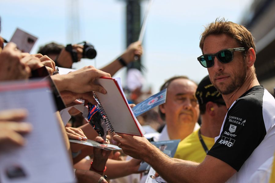 Jenson Button signs for a fan