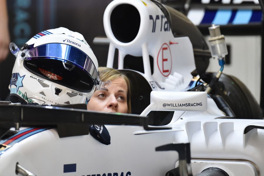 Susie Wolff sits in the Williams cockpit in the garage