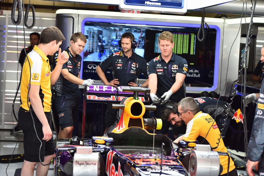 Mechanics work on Daniel Ricciardo's RB11 in the garage