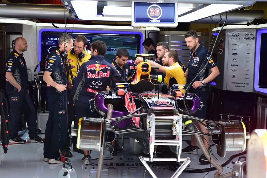 Red Bull mechanics work on the Daniil Kvyat's car