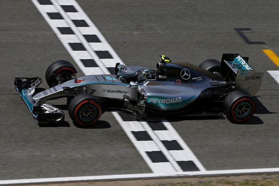 Race winner Nico Rosberg crosses the line
