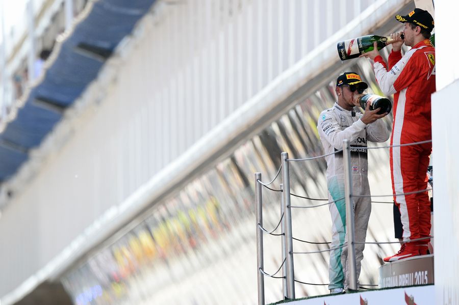 Lewis Hamilton and Sebastian Vettel enjoy the champagne on the podium