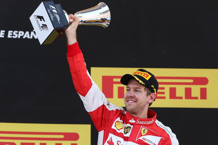 Sebastian Vettel celebrates with his trophy on the podium