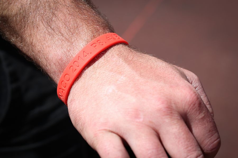 Manor Marussia team members wear wristbands remembering the points finish at the Monaco GP 2014 of Jules Bianchi