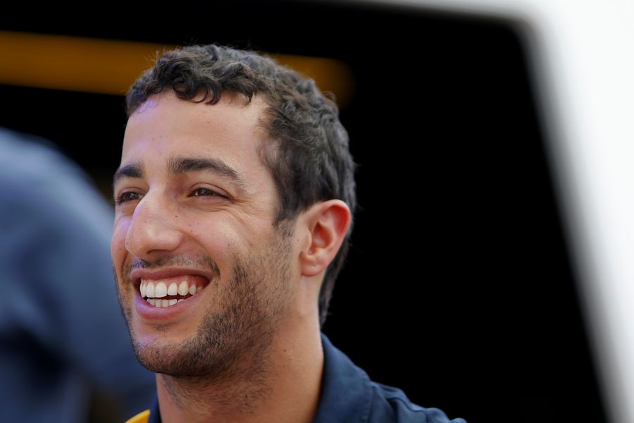 Daniel Ricciardo relaxes in the paddock
