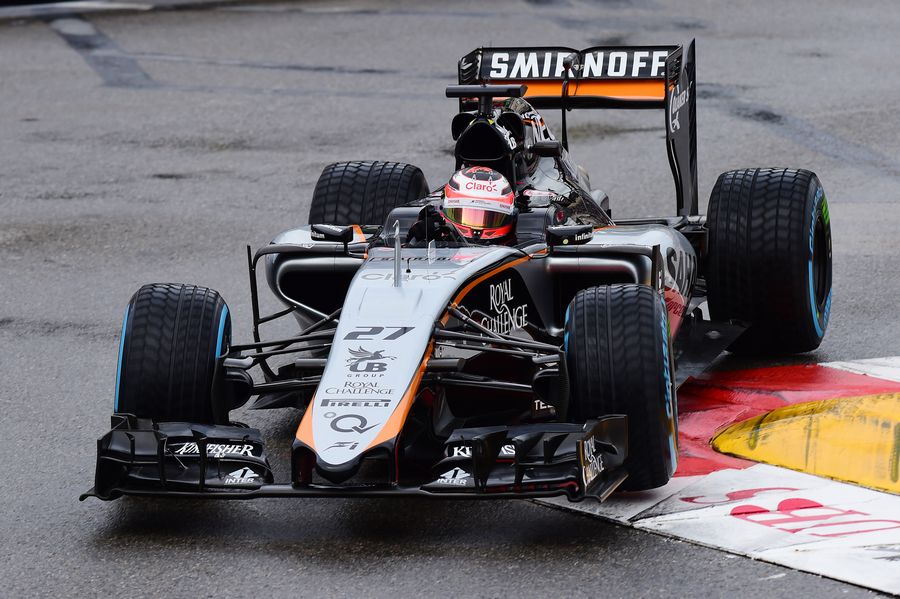Nico Hulkenberg on the wet tyre bounces over a kerb