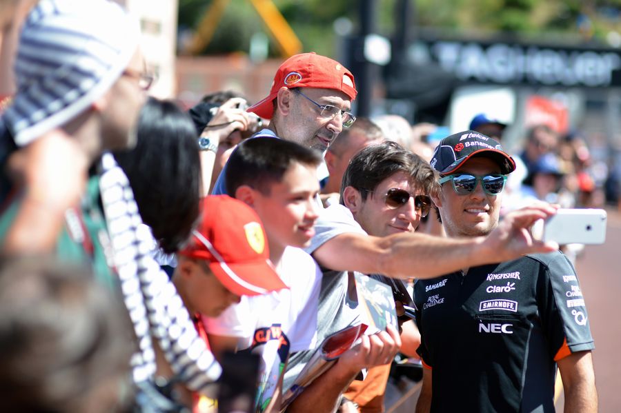 Sergio Perez poses for a selfie with the fans