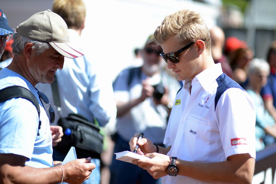 Marcus Ericsson signs an autograph for a fan