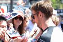 Jenson Button signs autographs for the fans