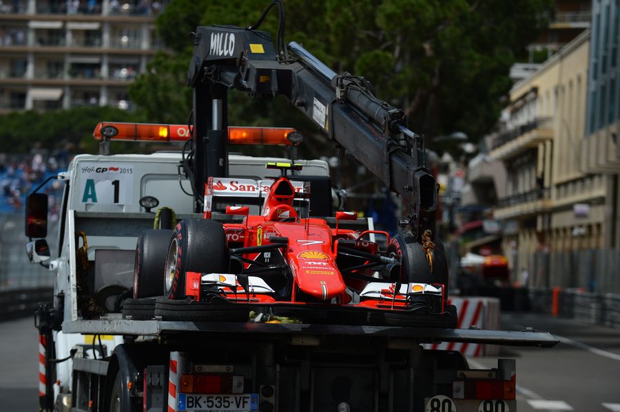 The car of Kimi Raikkonen's Ferrari SF15-T returns to pit