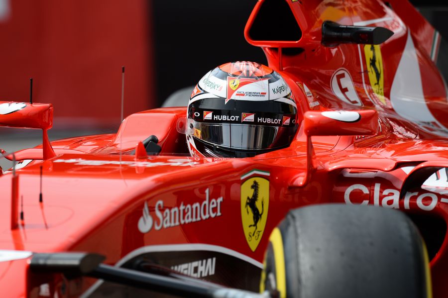Kimi Raikkonen looks on from the cockpit of the Ferrari