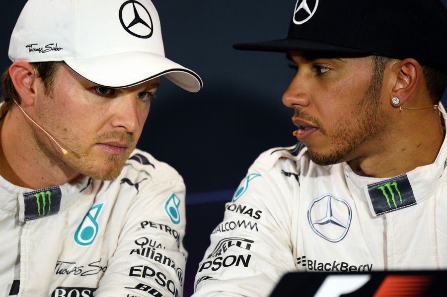 Lewis Hamilton talks to Nico Rosberg during the press conference