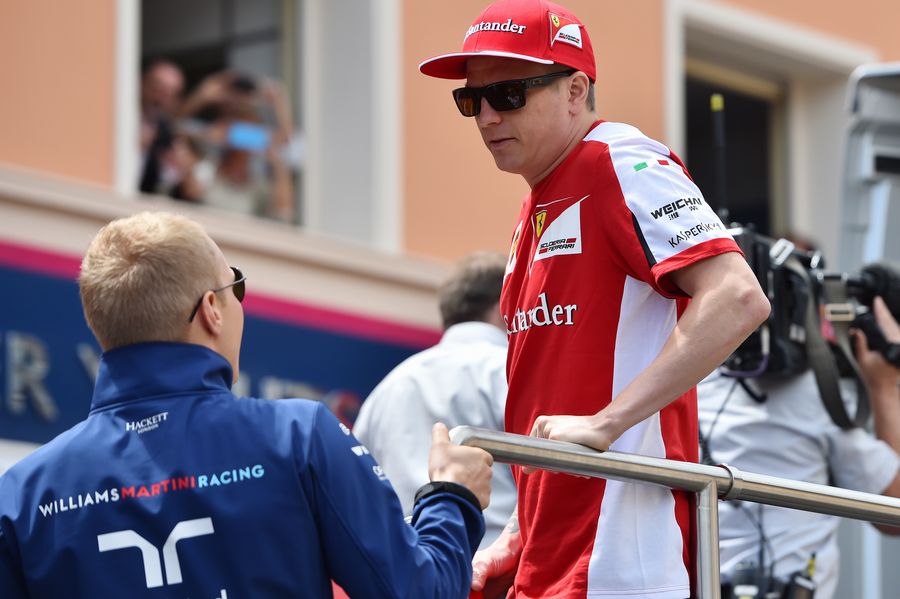 Valtteri Bottas and Kimi Raikkonen share a joke on the drivers parade