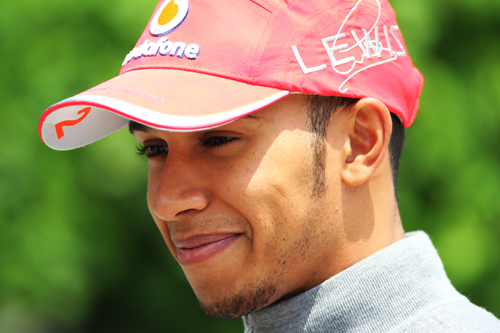 A smiling Lewis Hamilton arrives for the race