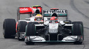 Michael Schumacher fights to hold off Lewis Hamilton