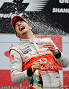 Jenson Button takes a hit from the champagne