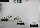 Jenson Button leads the field away after the restart