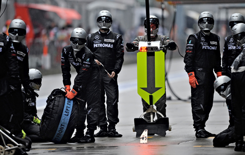 The Mercedes pit crew wait for Nico Rosberg