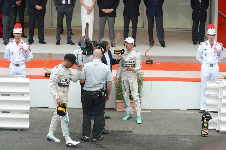 Lewis Hamilton walks quickly away from the podium