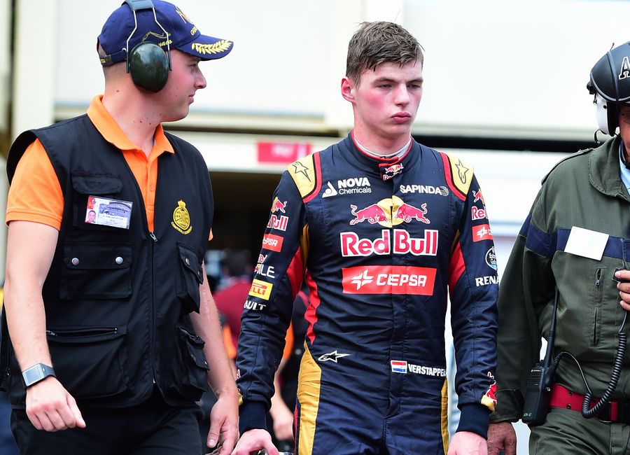 Max Verstappen walks to the pit after retirement