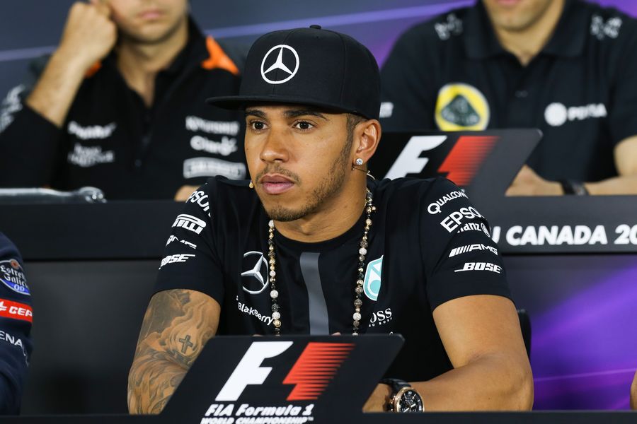 Lewis Hamilton looks on in the Thursday press conference