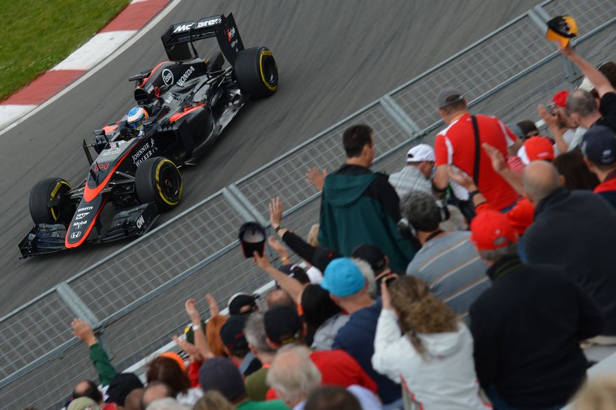 Fernando Alonso speeds past fans