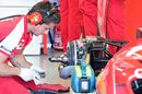 A Ferrari mechanic works on SF15-T's rear brake and wheel hub