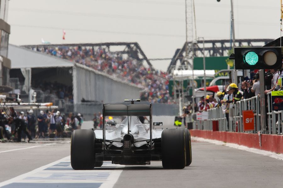 Nico Rosberg makes his way down the pit lane