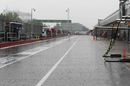 Heavy rain falls in the pit lane
