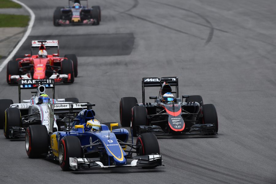 Marcus Ericsson and Felipe Massa pass Fernando Alonso