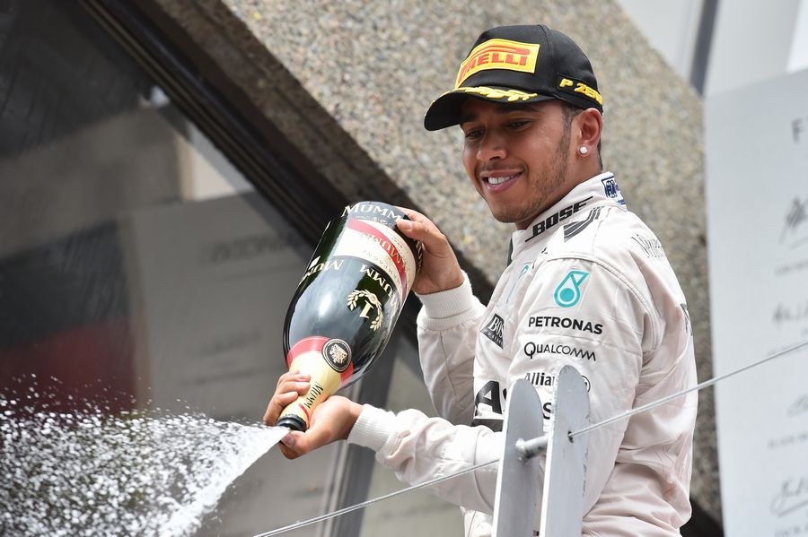 Lewis Hamilton sprays champagne on the podium