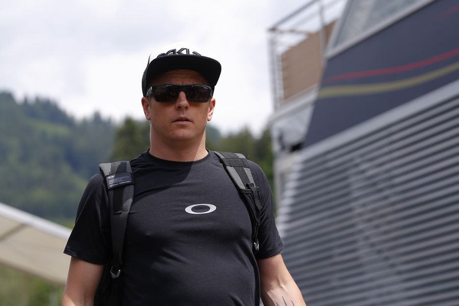 Kimi Raikkonen walks through the paddock