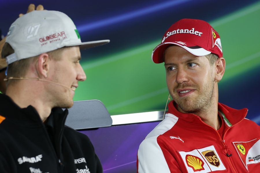 Nico Hulkenberg and Sebastian Vettel chat during the driver press conference