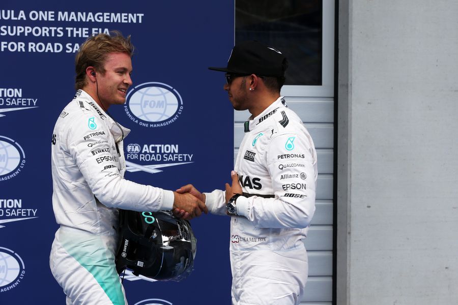 Nico Rosberg celebrates pole sitter Lewis Hamilton in parc ferme