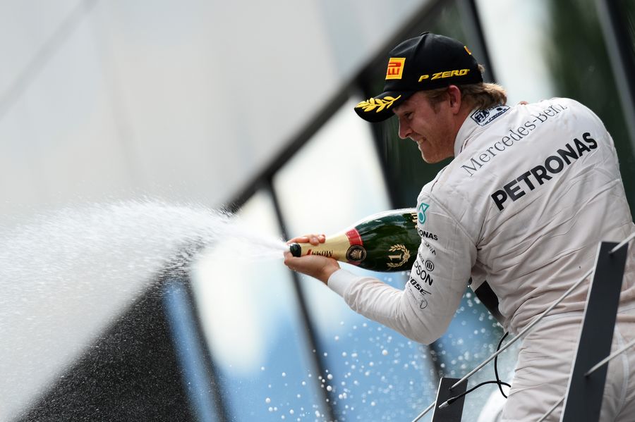 Nico Rosberg celebrates his win on the podium with the champagne