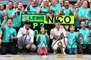 Nico Rosberg and Lewis Hamilton celebrate with the team for its 1-2 finish