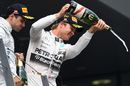 Nico Rosberg and Felipe Massa celebrate on the podium with the champagne
