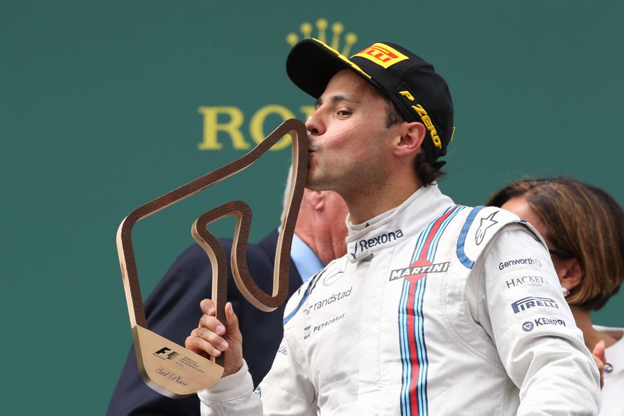 Felipe Massa kisses the trophy on the podium