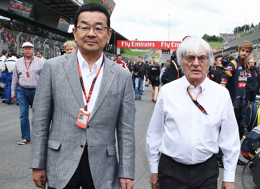 Takahiro Hachigo and Bernie Ecclestone walk down the grid